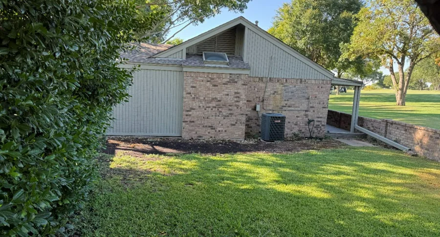 Residential side yard and patio evaluated during a Dallas–Fort Worth drainage assessment